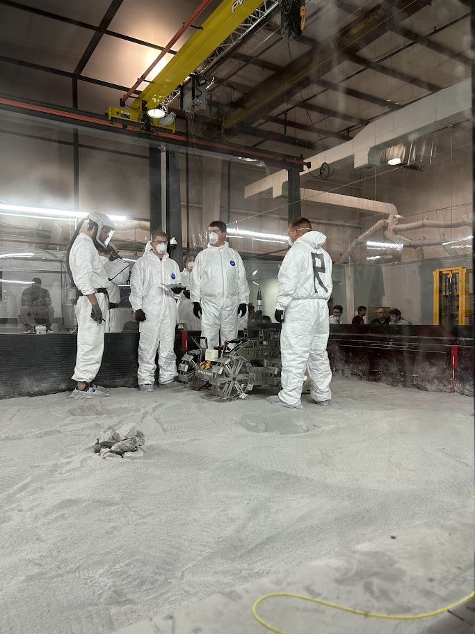 Team setting up the rover in the competition pit